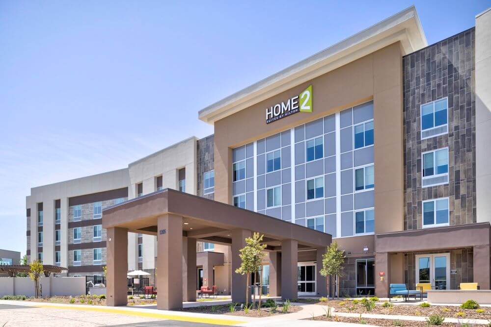 Home2 Suites view of property from parking lot. Covered walkway to lobby.