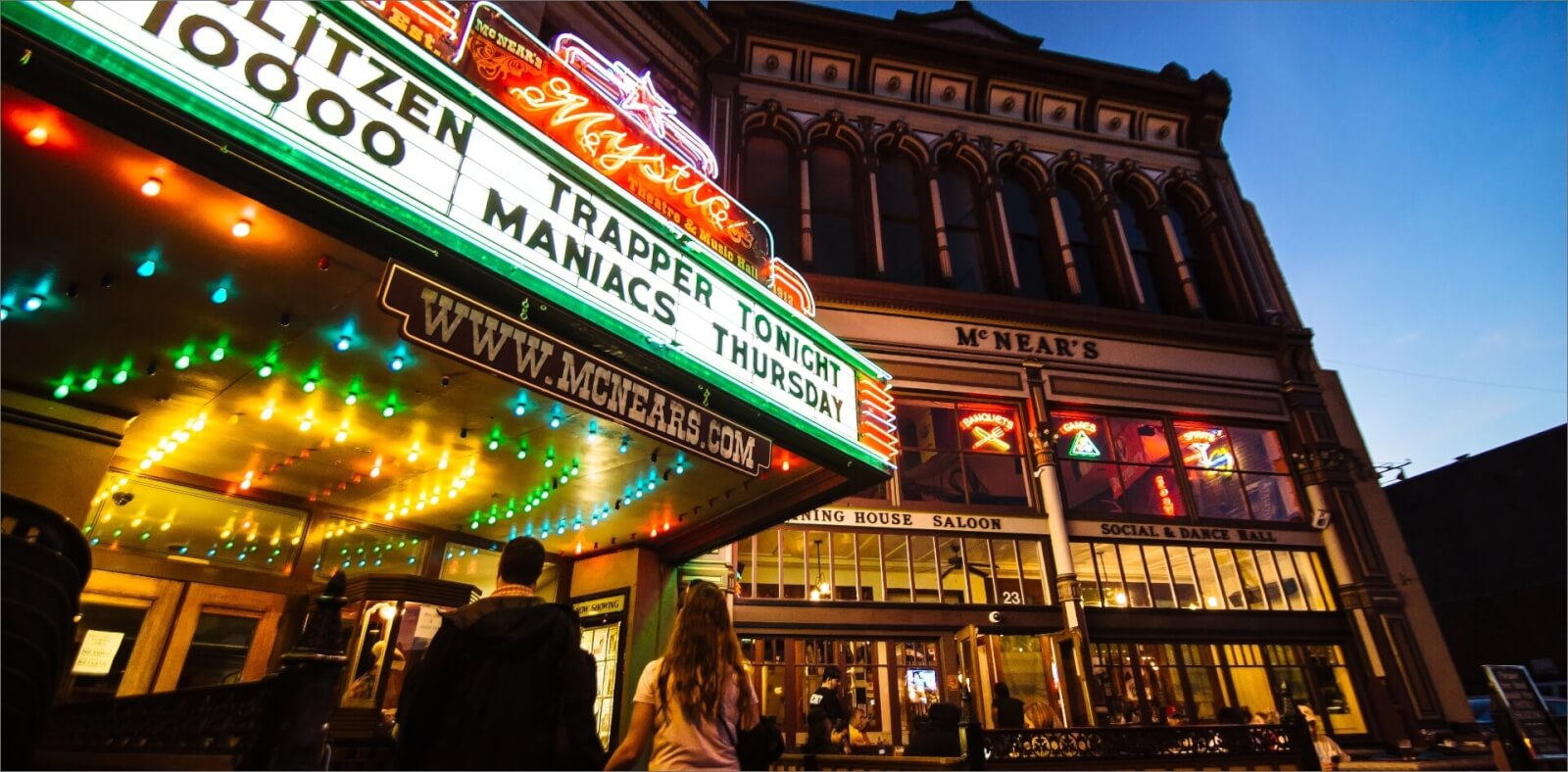 Mystic Theatre marquis at night with historic building in background